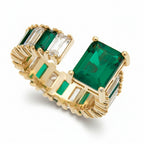 Gold ring with rectangular green and clear cubic zirconia stones on a white background