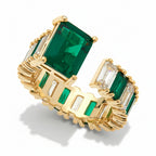 Gold ring with rectangular green and clear cubic zirconia stones on a white background