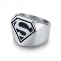 A silver-toned stainless steel metal signet ring featuring a black and silver Superman 'S' shield emblem on the face, shown on a clean white background.