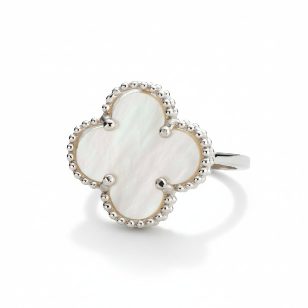 silver-toned ring with a pearlescent mother of pearl clover-shaped stone on a white background